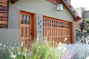 example of a wooden garage door with windows that has great curb appeal